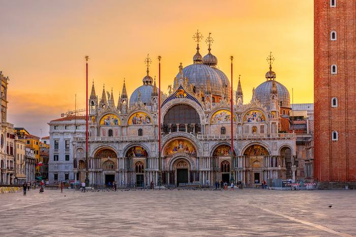 St. Mark’s Square in Venice with historic buildings and basilica at sunset
