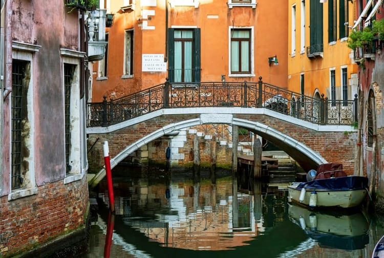 Quaint pedestrian bridge over a quiet canal in Dorsoduro, Venice
